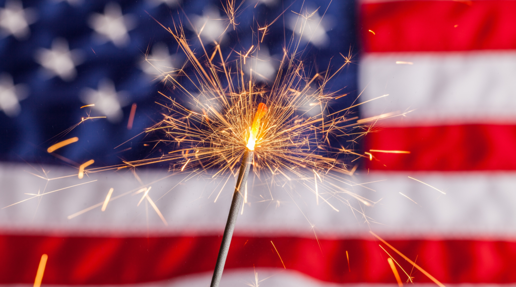 picture of sparkler in front of the American flag
